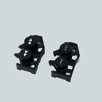 Dua part hitam hasil cetak 3D dari file yang sudah diperbaiki